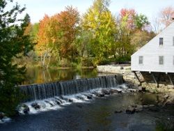 photo ofthe falls at Falls at The Cooperage in Townsend Harbor showing trees of Autumn colors in the background - Thank You to Cheryl Forest
